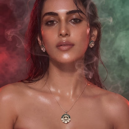 "Gold-tone kundan polki necklace and earring set with emerald-green enamel detailing and round uncut diamond-style pendant, on white background"