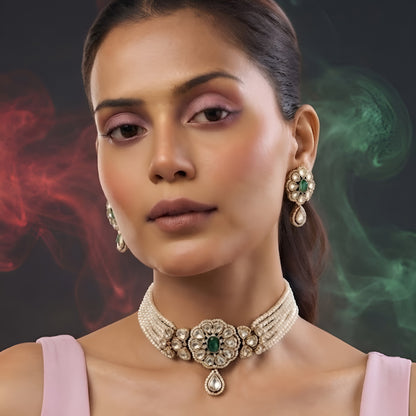 Gold-plated multi-strand pearl choker necklace set with emerald green floral kundan medallion, teardrop pendant and matching stud earrings