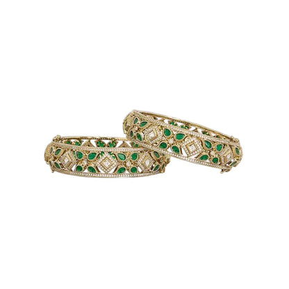 "Set of two gold-toned openwork bangles with emerald-green marquise stones and white CZ floral motifs, traditional Indian jewelry"