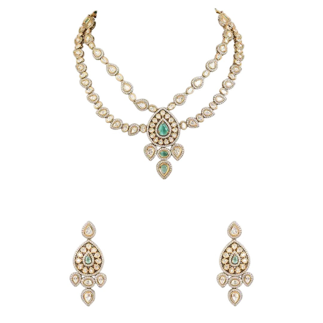 "Antique gold double-strand Kundan necklace with teardrop emerald pendant, matching drop earrings"