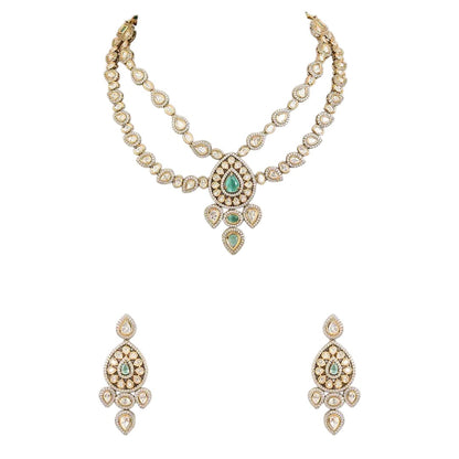 "Antique gold double-strand Kundan necklace with teardrop emerald pendant, matching drop earrings"