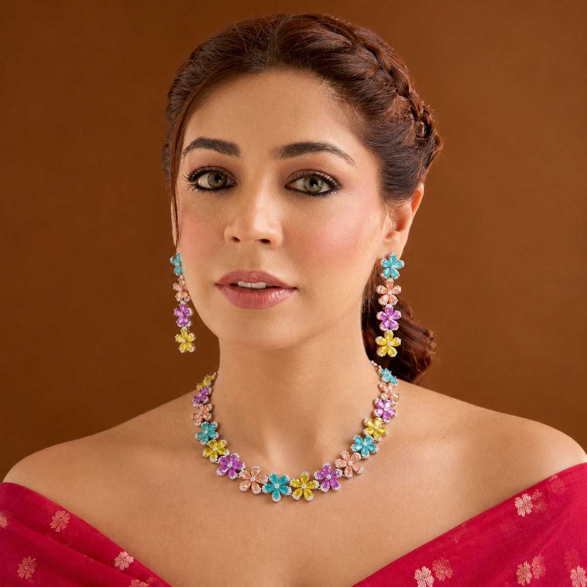 Silver plated multicolour flower American diamond necklace set with aqua, peach, pink and yellow stones and matching drop earrings on a marble slab