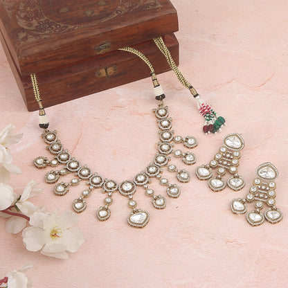 Gold plated Kundan necklace set with white stones and matching chandelier earrings for bridal and festive wear