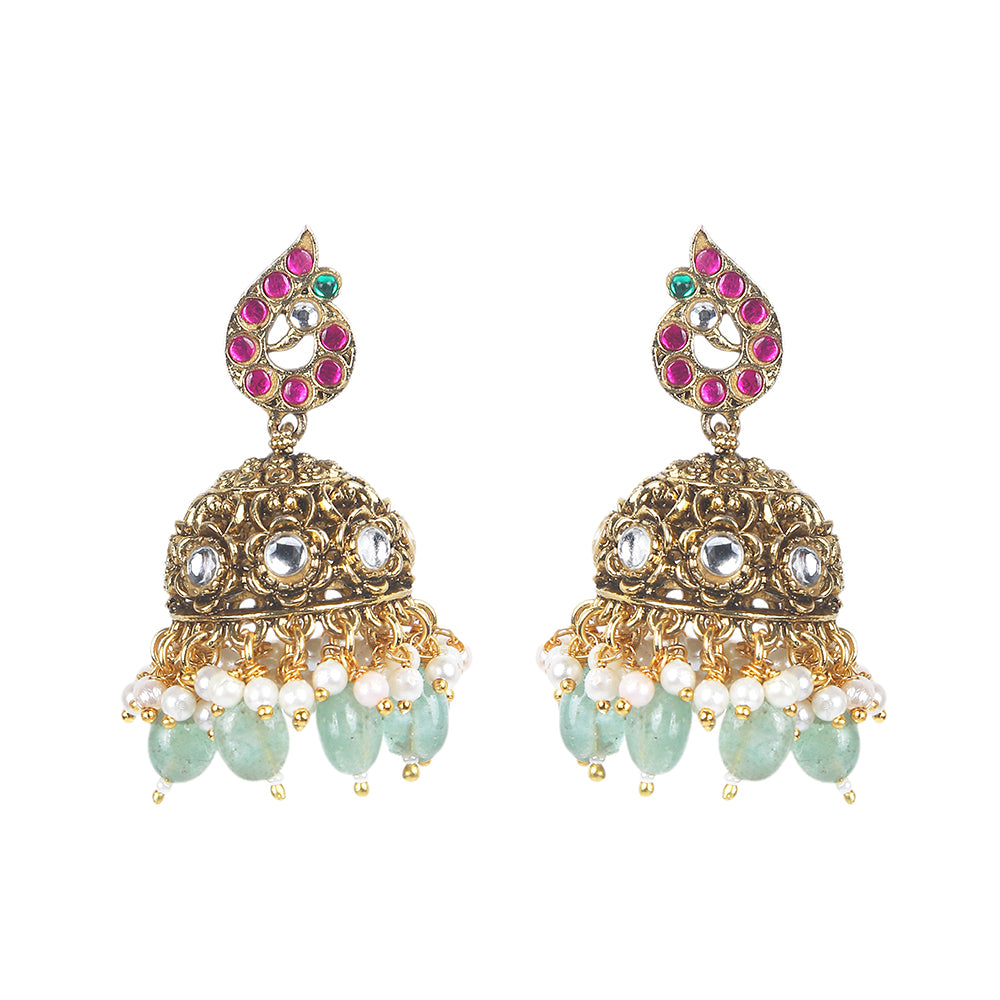 Gold plated temple Lakshmi bridal necklace set with pink green stones and jhumka earrings with pearl and bead drops on white background