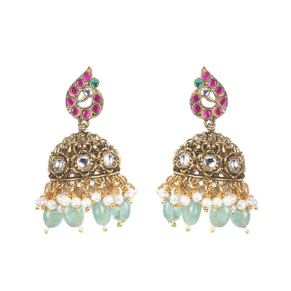 Gold plated temple Lakshmi bridal necklace set with pink green stones and jhumka earrings with pearl and bead drops on white background