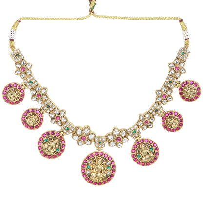 Gold plated Lakshmi coin necklace set with pink stones and matching earrings on white background