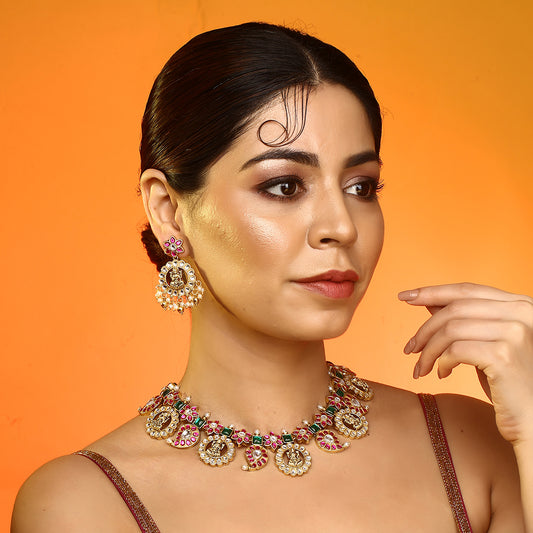 Gold plated temple Lakshmi necklace set with pink and green stones and matching earrings with pearl drops on white background