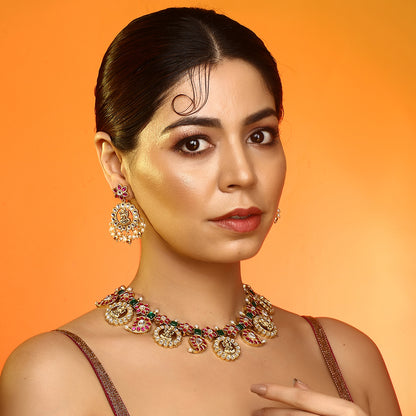 Gold plated temple Lakshmi necklace set with pink and green stones and matching earrings with pearl drops on white background