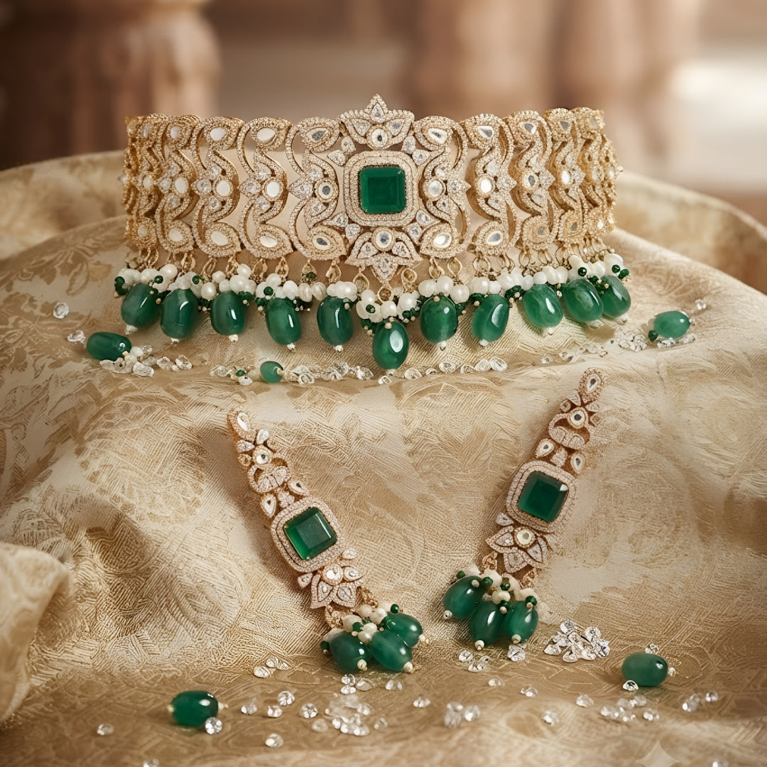 "Antique gold wide Kundan choker necklace with emerald and pearl bead drops, matching long drop earrings"