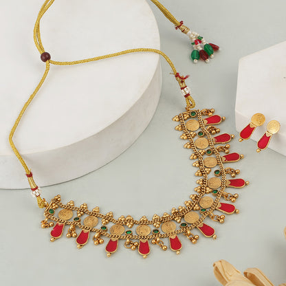 Aviana gold plated temple necklace set with red drops, green stones, and matching earrings on white background