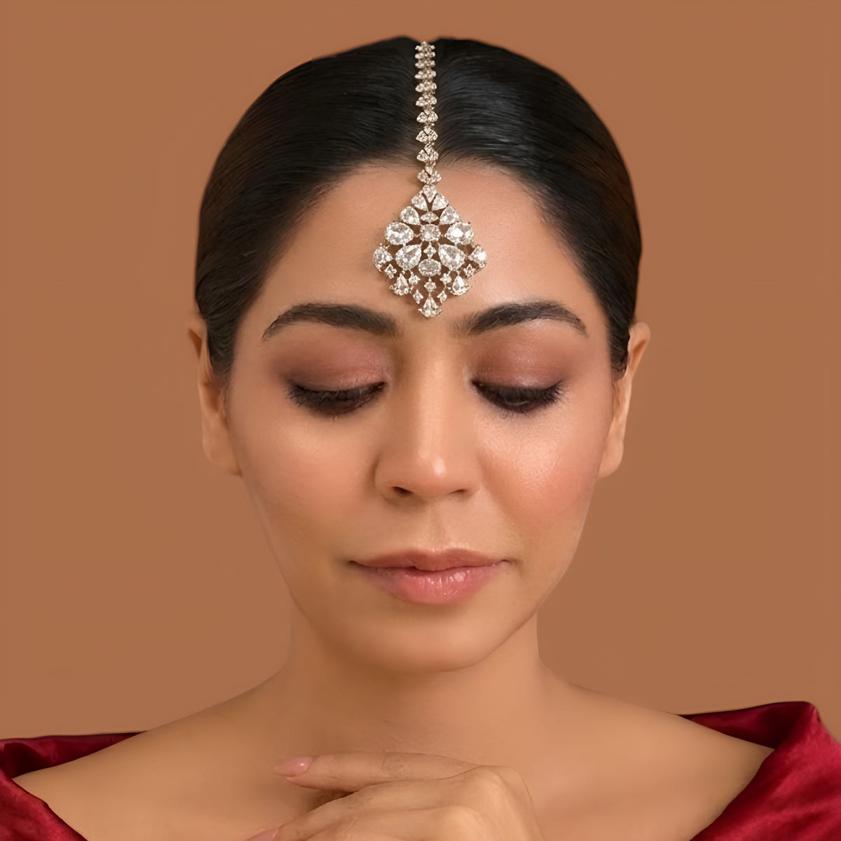 Gold finish American diamond maang tikka with clear pear-cut zircon stones, pave zircon accents and a leaf-shaped zircon chain – Auraa Trends