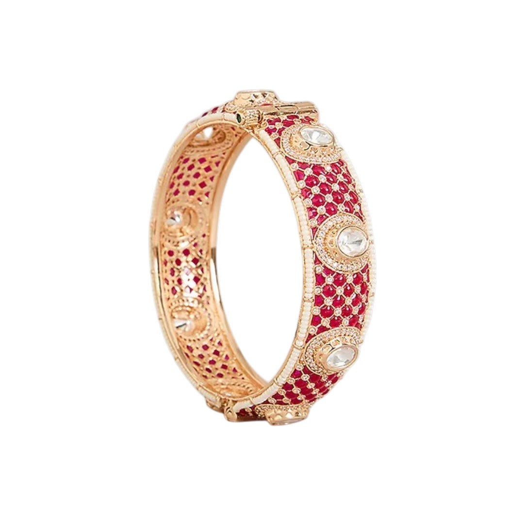 "Set of two gold-toned bangles with ruby-red kundan stone work, white polki stone accents and pearl border, traditional Indian bridal jewelry"