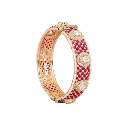 "Set of two gold-toned bangles with ruby-red kundan stone work, white polki stone accents and pearl border, traditional Indian bridal jewelry"
