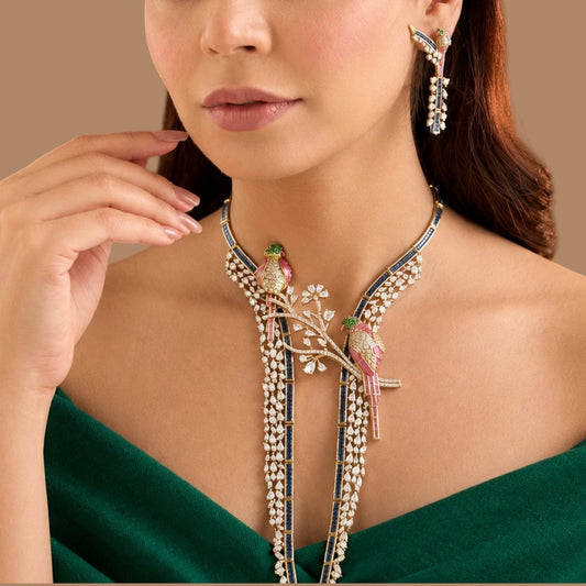 Gold plated designer parrot necklace set with pink enamel birds, American diamond branch, royal blue stone strands and matching parrot earrings