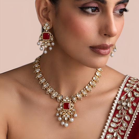 Gold finish kundan polki necklace set with ruby red square stone pendant and pearl drops