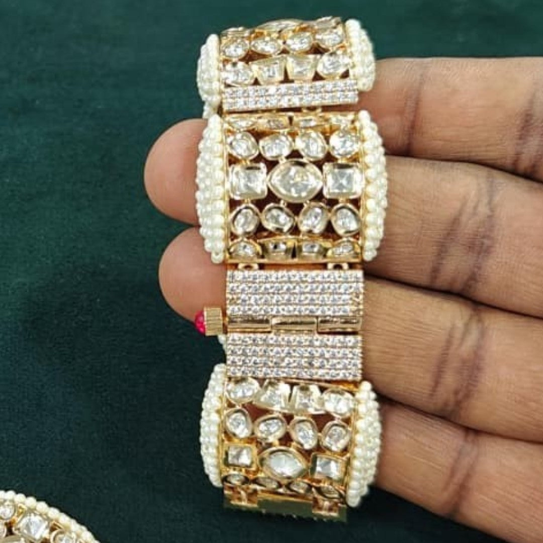 "Gold-tone bridal bracelet with pearl beading and white kundan polki crystal panels"