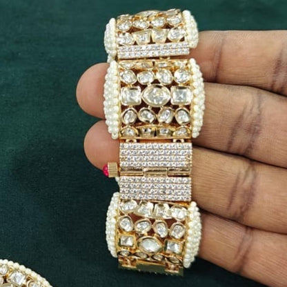 "Gold-tone bridal bracelet with pearl beading and white kundan polki crystal panels"