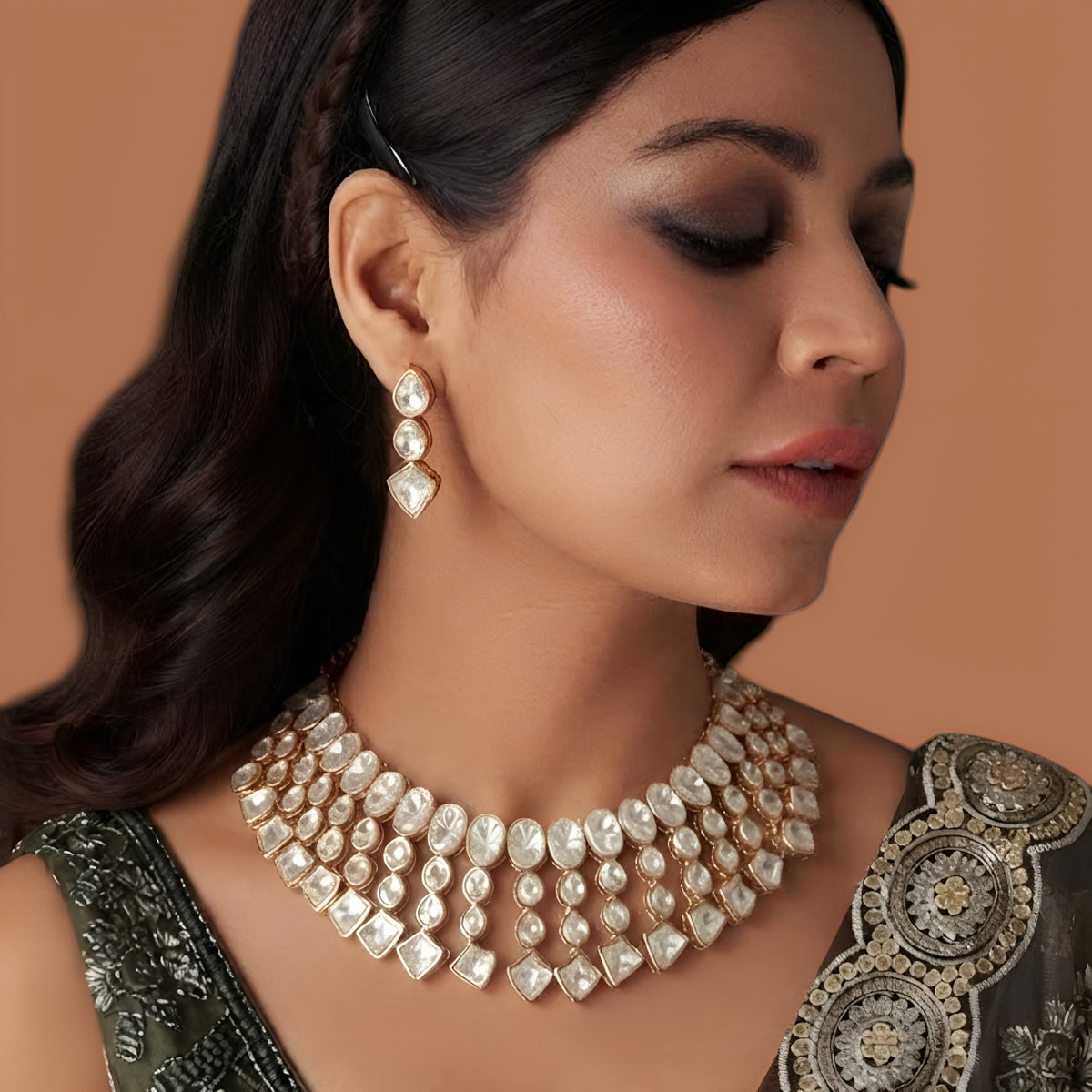 Model wearing gold plated polki kundan bib-style choker necklace with matching drop earrings
