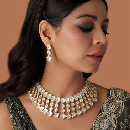 Model wearing gold plated polki kundan bib-style choker necklace with matching drop earrings