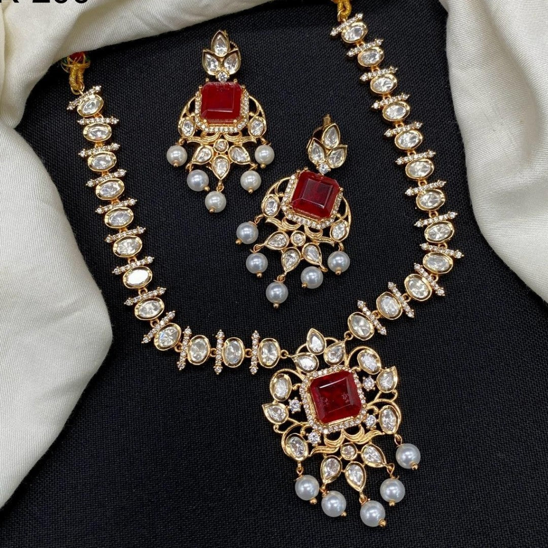 Gold finish kundan polki necklace set with ruby red square stone pendant and pearl drops