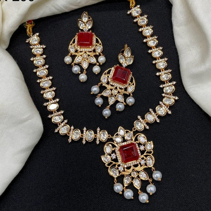 Gold finish kundan polki necklace set with ruby red square stone pendant and pearl drops