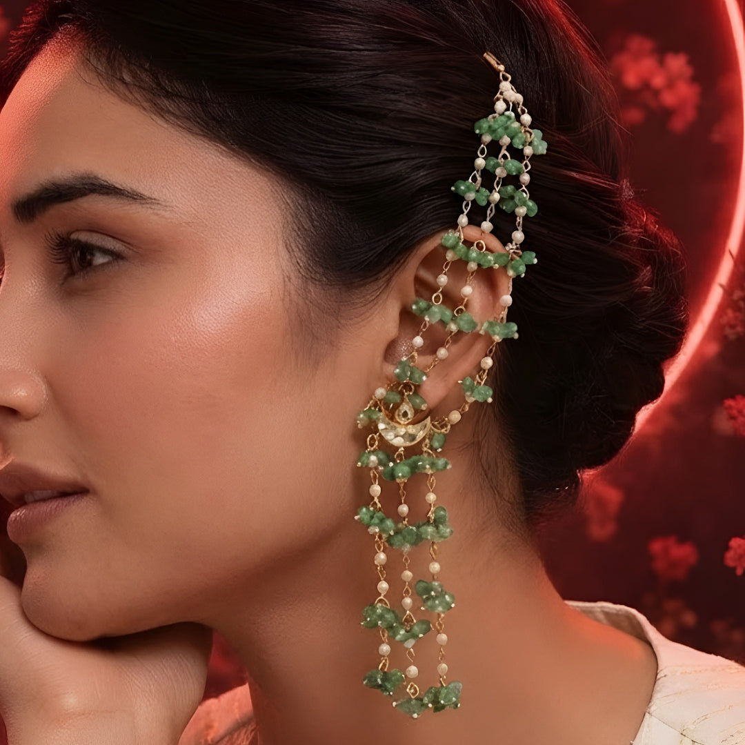 "Gold ear cuff earring with cascading green onyx beads and pearls, worn by model with dark hair in updo"