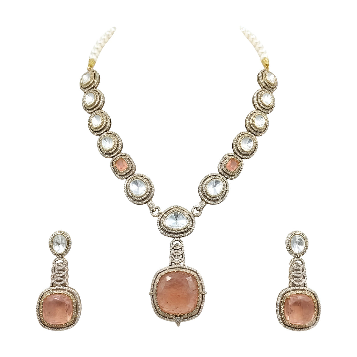 Antique gold Victorian kundan necklace with a large square peach-pink pendant and matching drop earring on a grey display bust