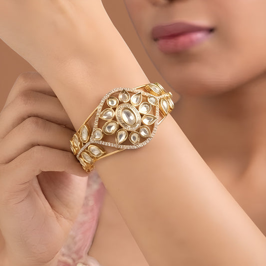 Gold finish kundan polki kada bangle with floral teardrop medallion and zircon border