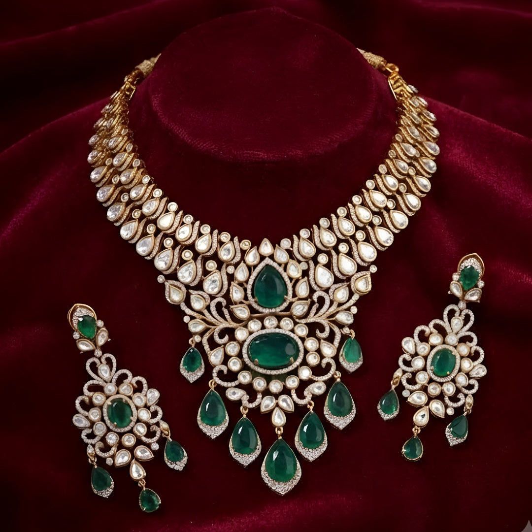 Gold kundan polki bridal necklace set with emerald green pear and oval stones, teardrop drops and matching chandelier earrings