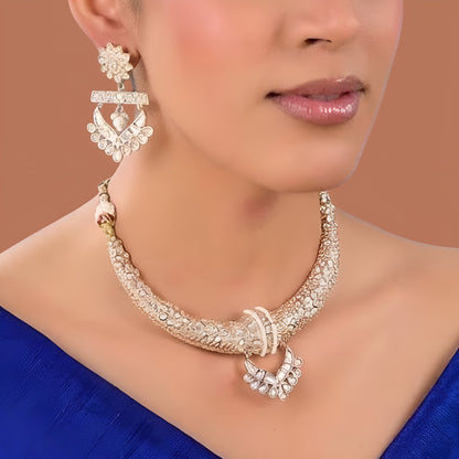 Gold-tone American Diamond designer necklace with textured stone detailing, statement pendant, and matching drop earrings styled on a model.