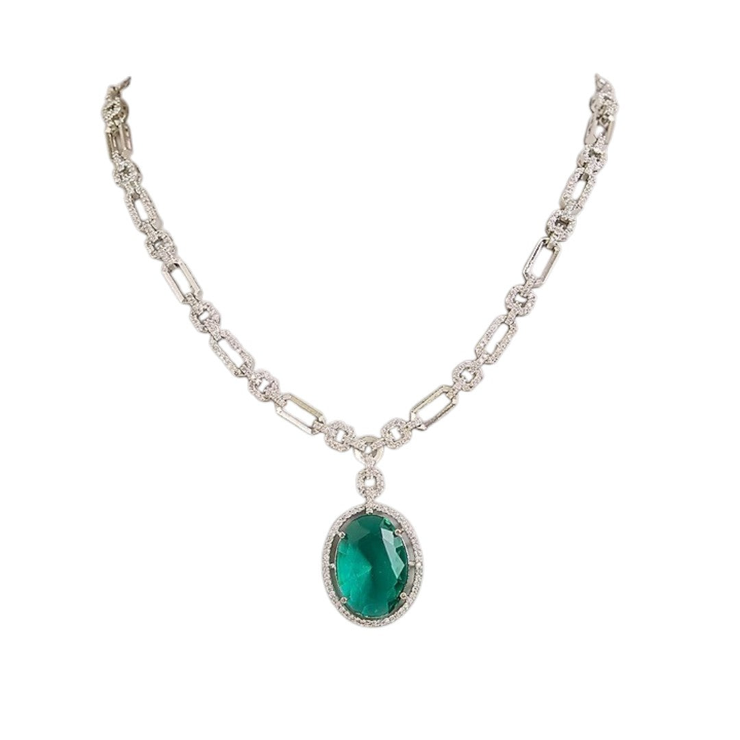 Silver plated American Diamond necklace set with emerald green oval pendant and matching drop earrings on white background