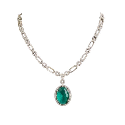 Silver plated American Diamond necklace set with emerald green oval pendant and matching drop earrings on white background
