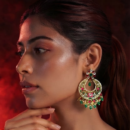"Gold polish Kundan Meenakari chandbali earrings with pink and green stones, green bead drops and pearl fringe on mannequin display"