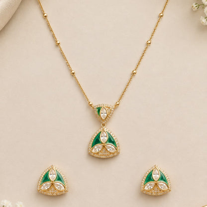 "Gold-tone triangular pendant necklace and earring set with green enamel detailing and marquise-cut clear crystal accents, on white background"