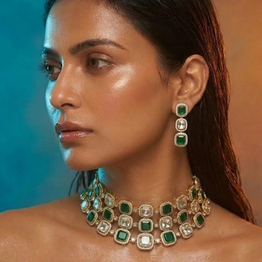 Luxury emerald green and white stone choker necklace set with matching earrings on white background.