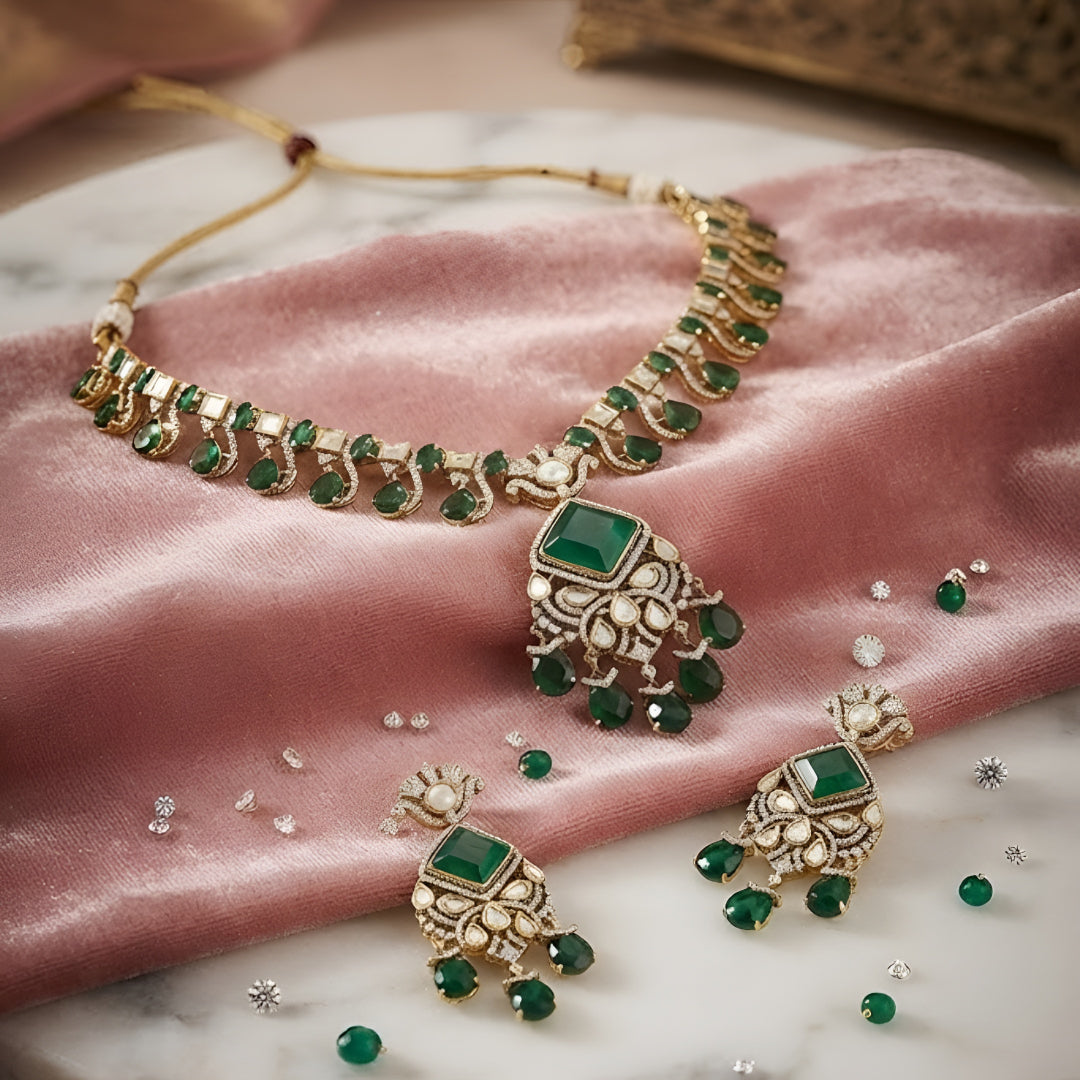 "Antique gold Kundan necklace with square-cut emerald pendant and teardrop drops, matching drop earrings"