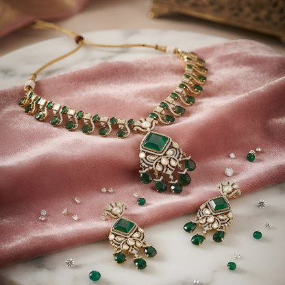 "Antique gold Kundan necklace with square-cut emerald pendant and teardrop drops, matching drop earrings"