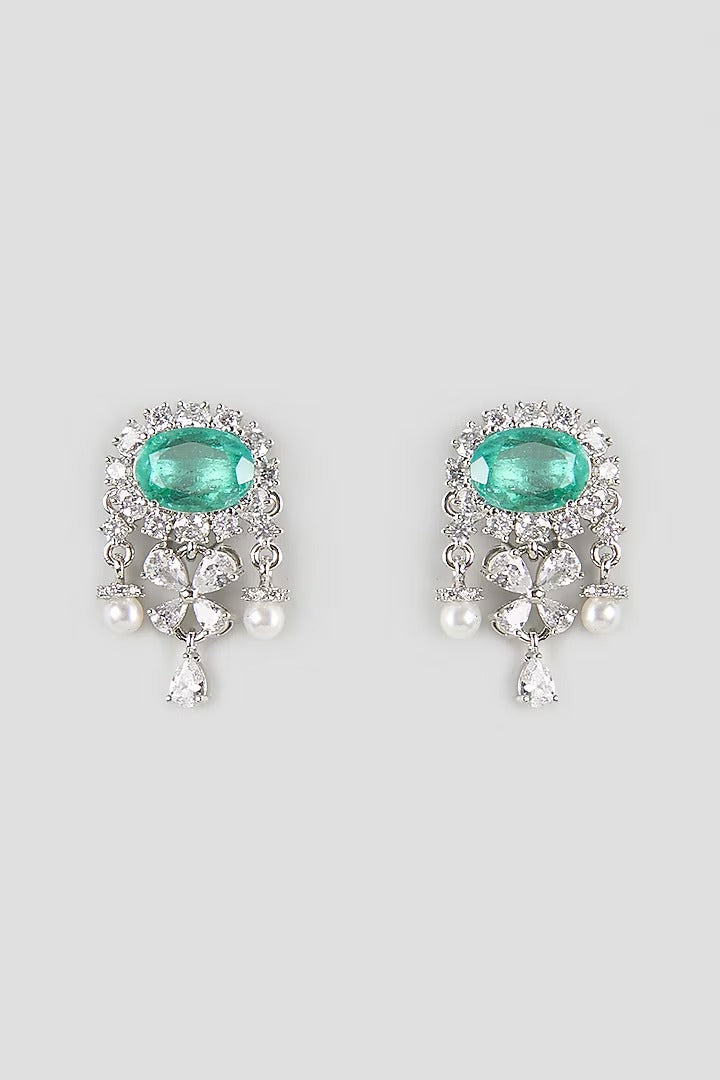 "Silver rhodium-plated drop earrings with oval emerald stone, diamond halo, clover-shaped white stones and pearl bead accents"