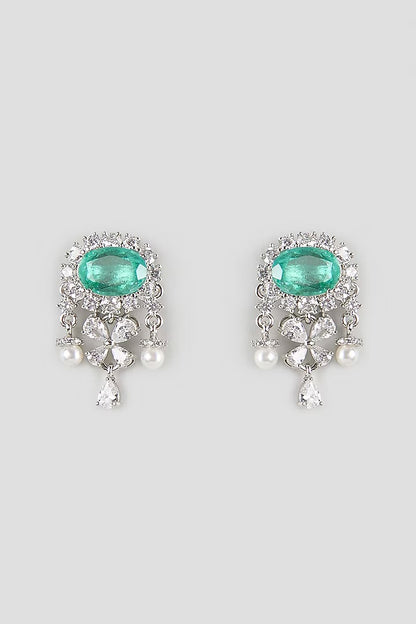 "Silver rhodium-plated drop earrings with oval emerald stone, diamond halo, clover-shaped white stones and pearl bead accents"