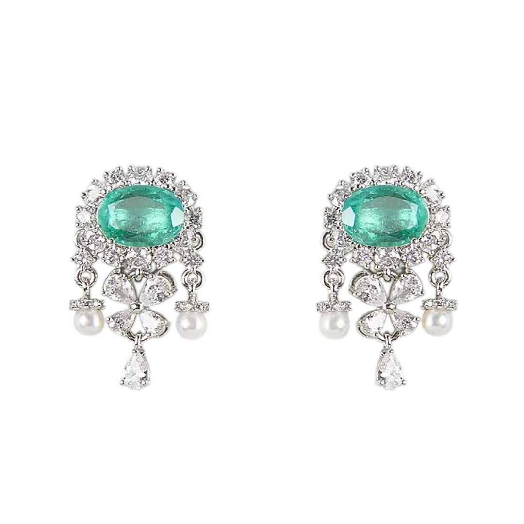 "Silver rhodium-plated drop earrings with oval emerald stone, diamond halo, clover-shaped white stones and pearl bead accents"