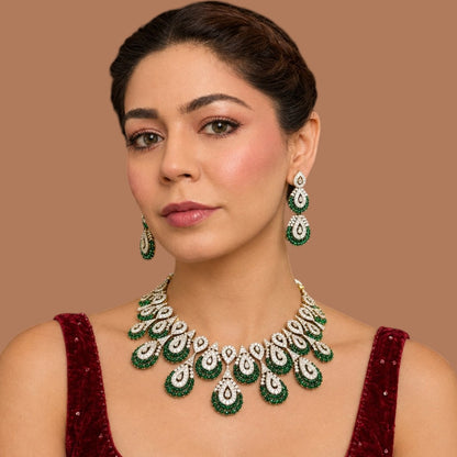 Victorian-style American diamond choker necklace set with emerald-green teardrop motifs and matching drop earrings on a grey display bust