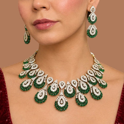 Victorian-style American diamond choker necklace set with emerald-green teardrop motifs and matching drop earrings on a grey display bust
