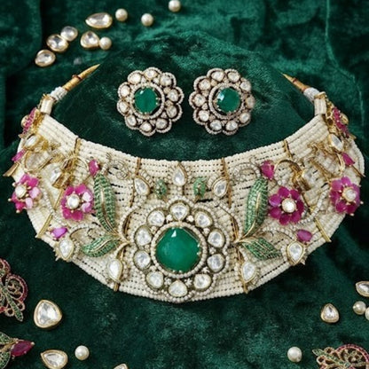Designer gold-plated Kundan pearl choker necklace set with green centerpiece, floral pink stones, and matching stud earrings for women.