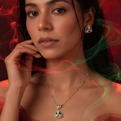 "Gold-tone triangular pendant necklace and earring set with green enamel detailing and marquise-cut clear crystal accents, on white background"