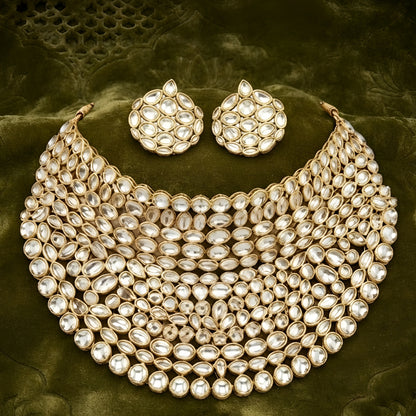 "Gold-tone kundan studded bib-style bridal necklace set with matching round stud earrings on white background"