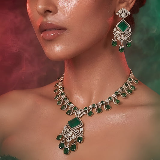"Antique gold Kundan necklace with square-cut emerald pendant and teardrop drops, matching drop earrings"