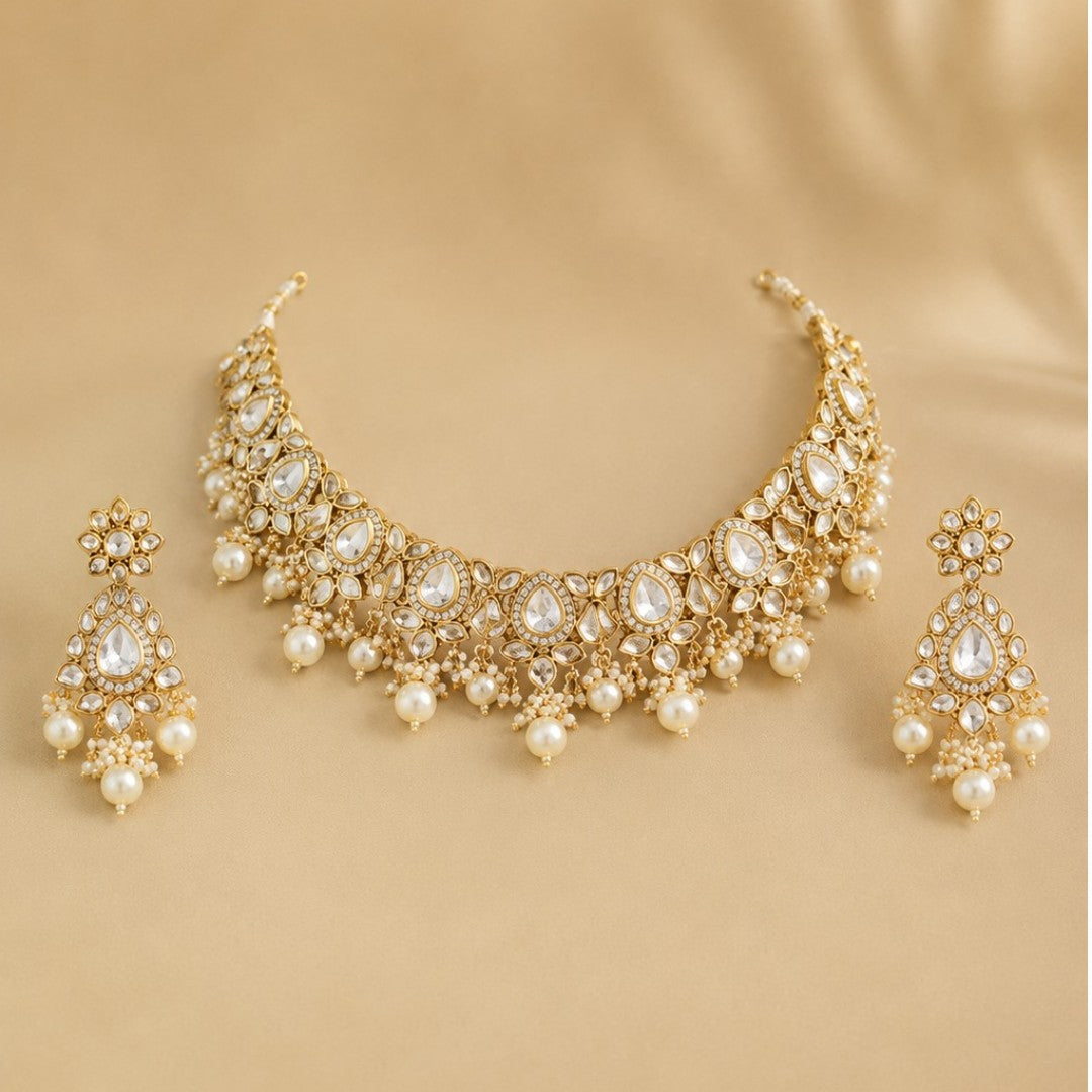 Gold-plated Kundan pearl choker necklace set with American diamond stones and matching pearl drop earrings for bridal, wedding, and festive wear.