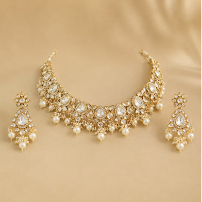 Gold-plated Kundan pearl choker necklace set with American diamond stones and matching pearl drop earrings for bridal, wedding, and festive wear.