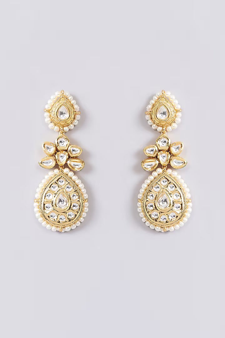 Gold-toned bridal kundan necklace set with pearl edging, maang tikka, and matching jhumka earrings