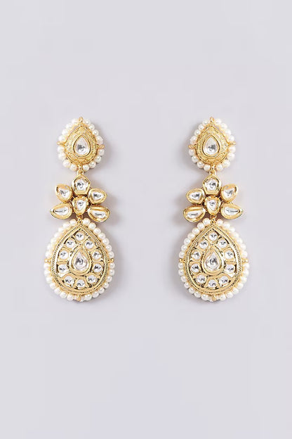 Gold-toned bridal kundan necklace set with pearl edging, maang tikka, and matching jhumka earrings